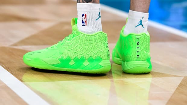 A detailed view of green Puma shoes.